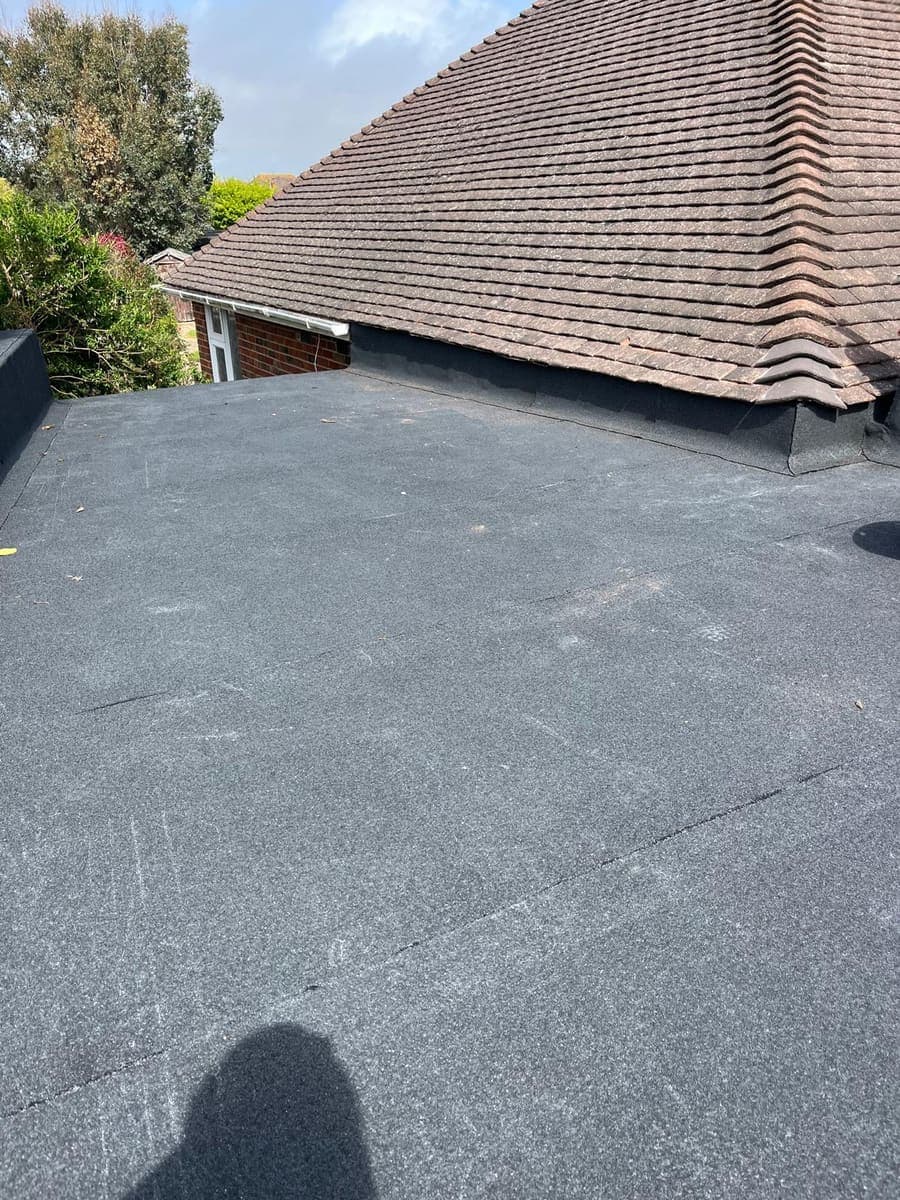 Finished flat roof extension abutting a tiled roof, West Sussex